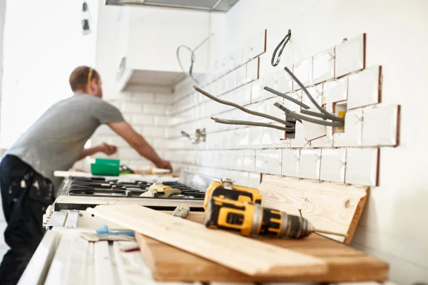 a-man-working-in-a-new-kitchen-a-tiler-applying-t-2026-01-09-10-06-07-utc