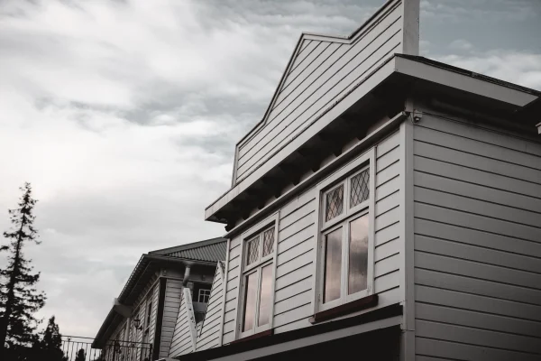 facade-of-old-wooden-house-with-square-white-windo-2026-01-07-01-45-38-utc